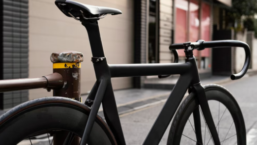 black bicycle on the street, building behind it